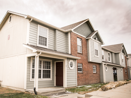 font side of a two story apartment complex with grey and brick accents